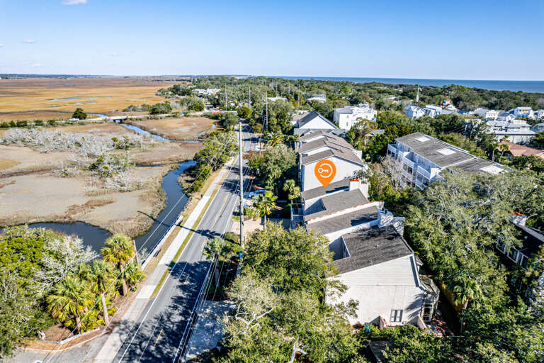 Aerial View Of Coastal Road With Marshes And Buildings