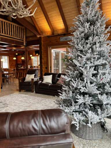 Frosted Artificial Christmas Tree In A Cozy Cabin Interior Frosted Artificial Christmas Tree In A Cozy Cabin Interior