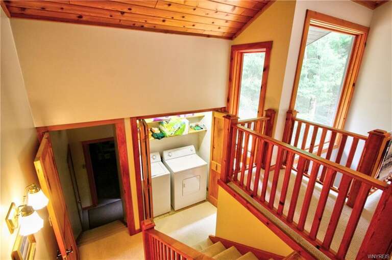 Interior Of Vacation Rental With Staircase And Laundry Area