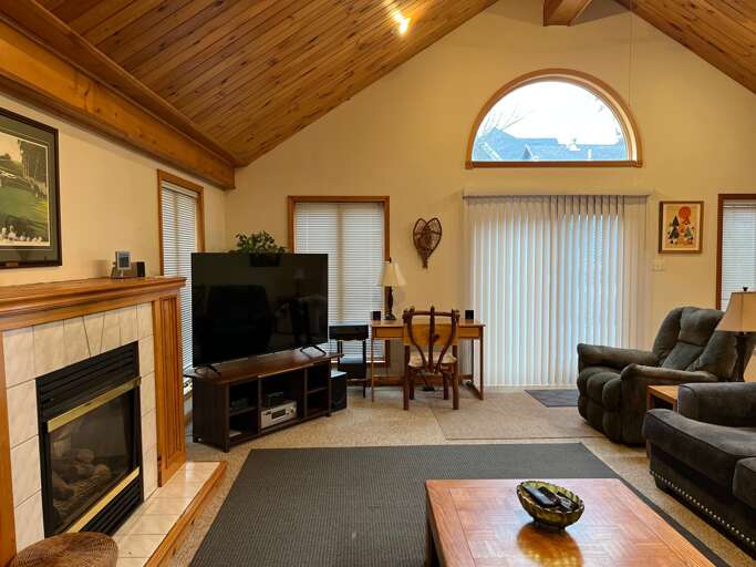 Living Room With Fireplace, Furniture, And TV