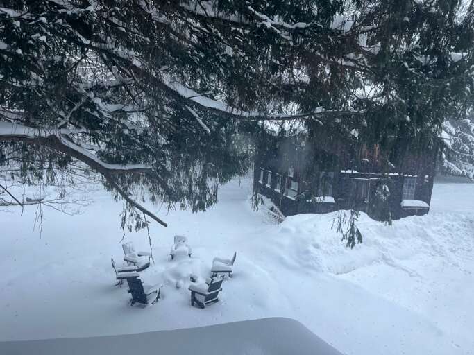 Snowy outside with plenty of parking and firepit