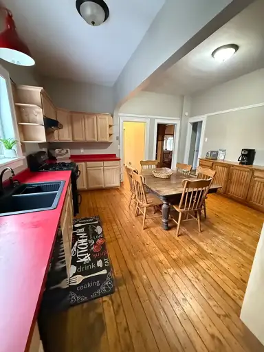 Vacation Rental Vista Revealing Rustic Kitchen, Wooden Dining Set, Radiant Lighting