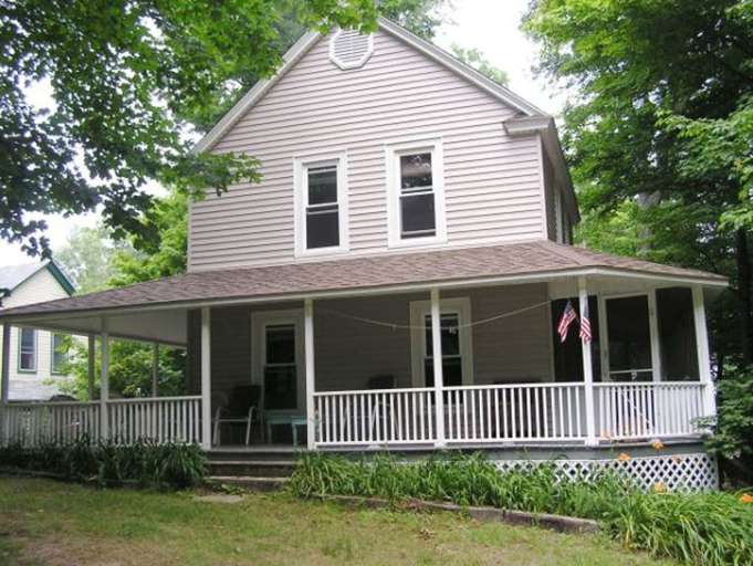 SIDE VIEW OF HOUSE SHOWING WRAP AROUND PORCHES