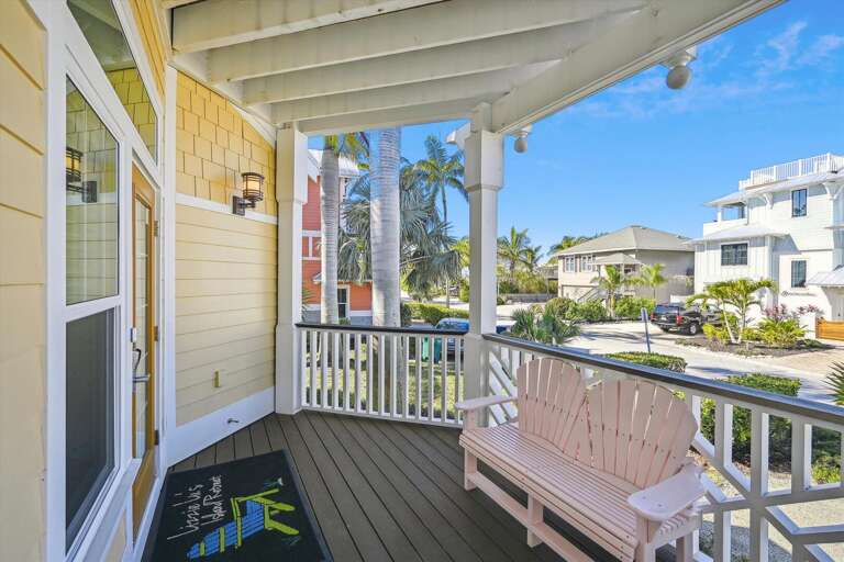 Porch View Of A Palm-lined Street From A Bright Building