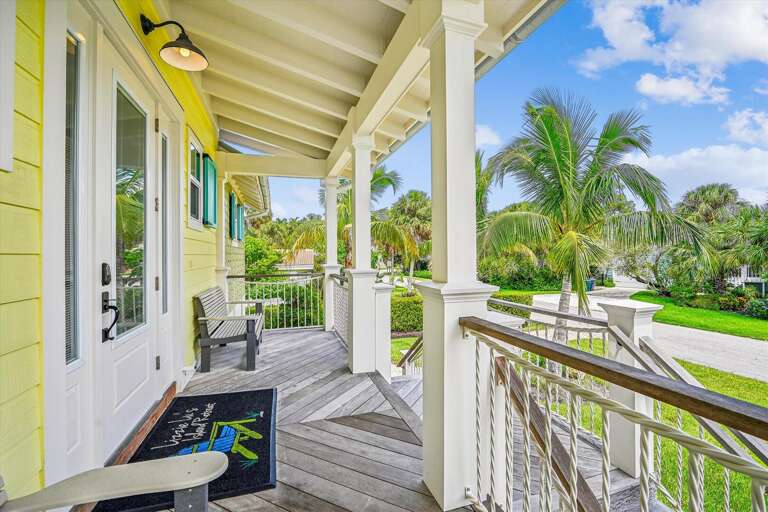 Bright Balcony With Palm Plants Surrounding, Part Of A Yellow Building