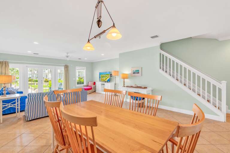 Bright open-concept dining area in a luxury Marathon Florida Keys waterfront vacation rental featuring seating for six, canal views, and seamless flow to the kitchen and living space.