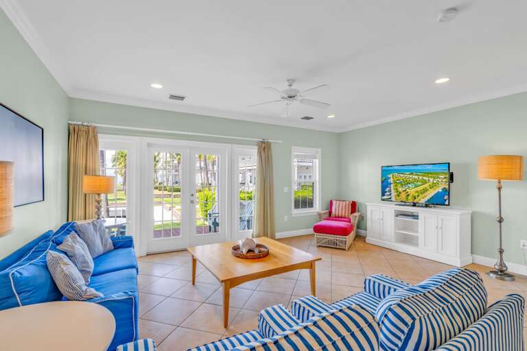 Bright waterfront lounge in a luxury Marathon FL vacation home with gulf access canal and resort-style outdoor space.