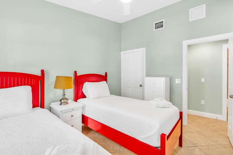 Spacious bedroom with two twin beds in a luxury Marathon Florida Keys pool home designed for group getaways and waterfront relaxation.