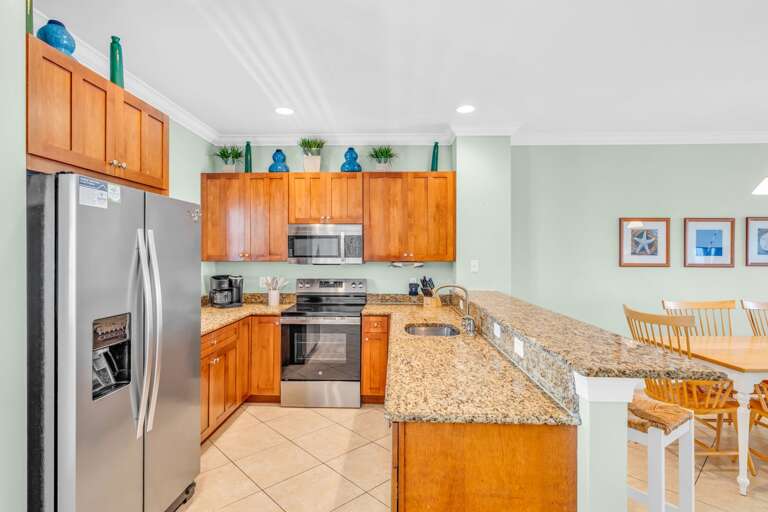 Stylish kitchen with quartz countertops and canal views in a luxury Florida Keys vacation rental featuring a community pool, dock, and boating access.
