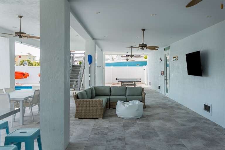 Outdoor living room with a flat-screen TV.