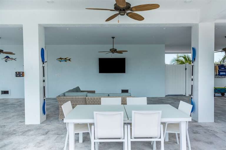 Outdoor living room with a flat-screen TV.