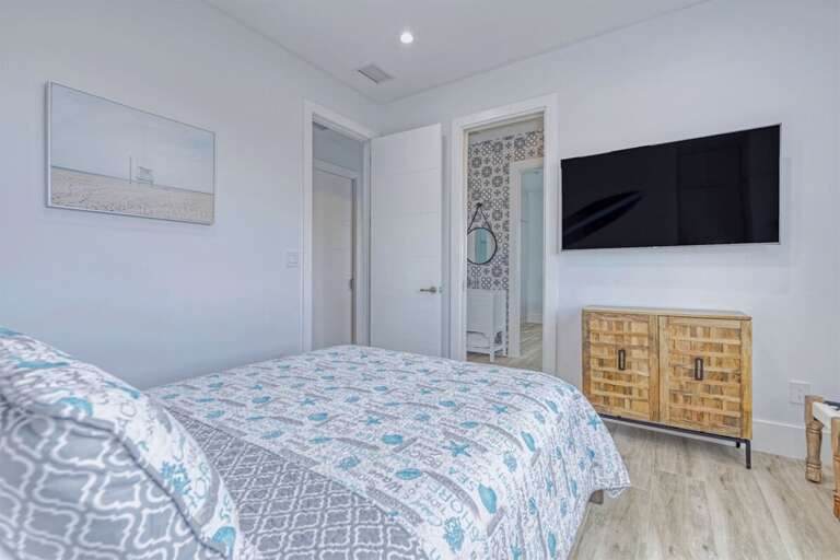 2nd level bedroom 3 with a Queen bed and smart TV.