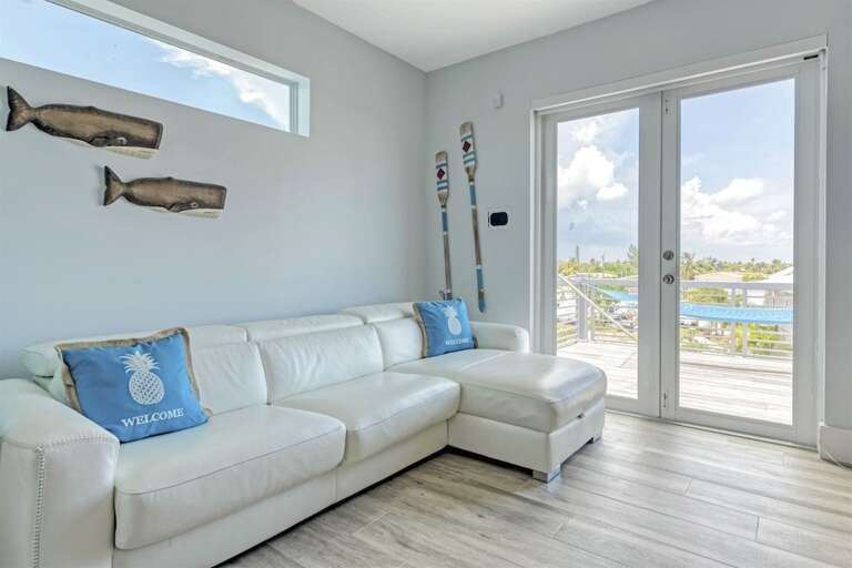 2nd level TV room leather couch equipped with fold out sleeper.