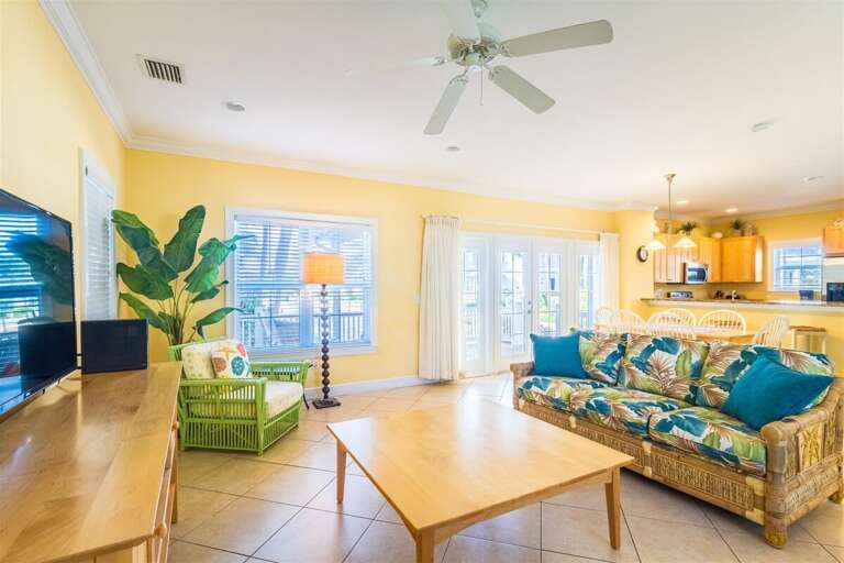 Sun-drenched relaxation awaits in our cozy living room, complete with TV and plush seating.