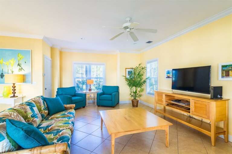 Sun-drenched relaxation awaits in our cozy living room, complete with TV and plush seating.