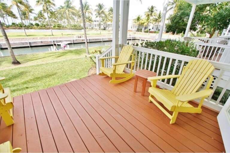 Relaxing porch space adorned with comfortable seating for unwinding outdoors.