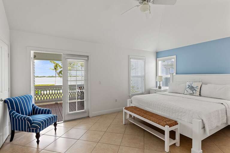 The master suite with a king size bed and en-suite bathroom.