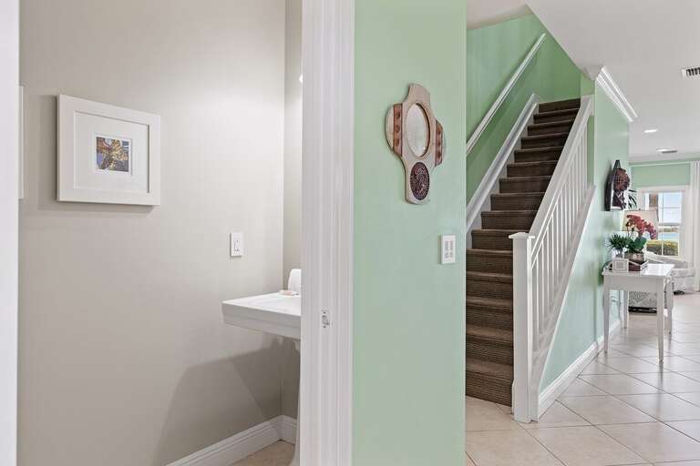 To the left is the half bathroom, stairs up to the 2nd floor accessed directly from the living room. To the left is the half bathroom, stairs up to the 2nd floor accessed directly from the living room.