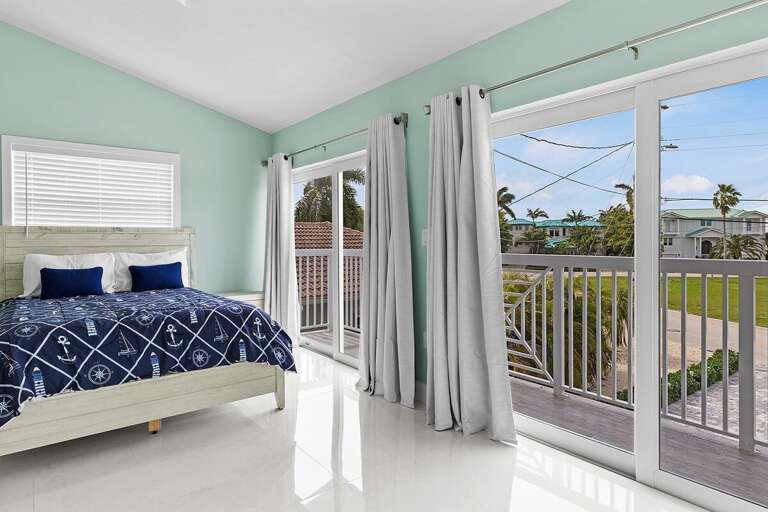 Bedroom 3 on the second level featuring a queen bed and en-suite full bathroom.