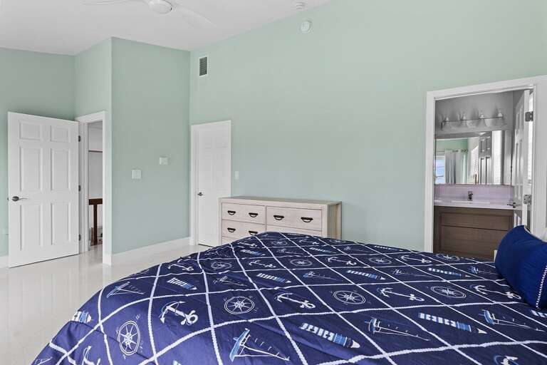 Bedroom 3 on the second level featuring a queen bed and en-suite full bathroom.