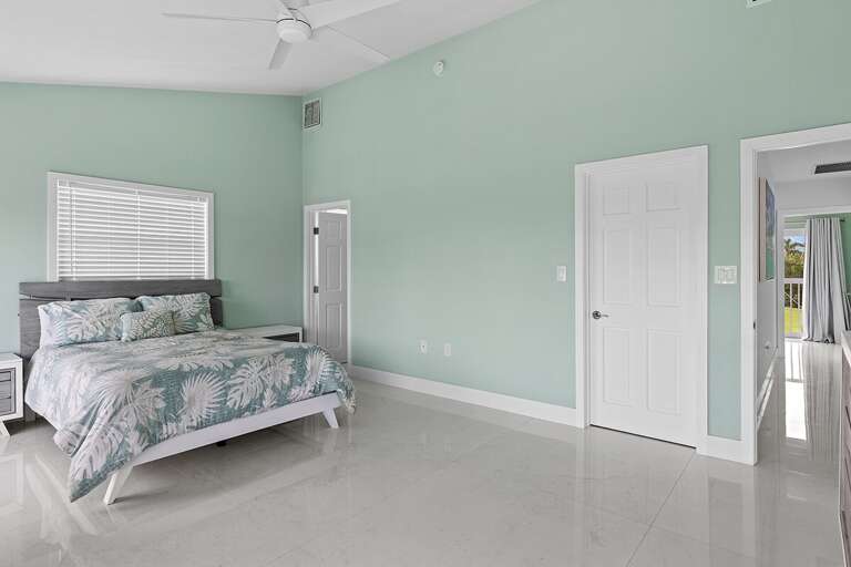 Bedroom 4 on the second level featuring a queen bed and en-suite full bathroom.