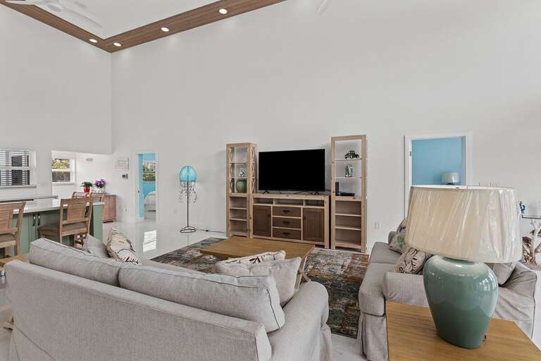 Comfortable sofas in the living area with a smart TV for relaxation and entertainment.