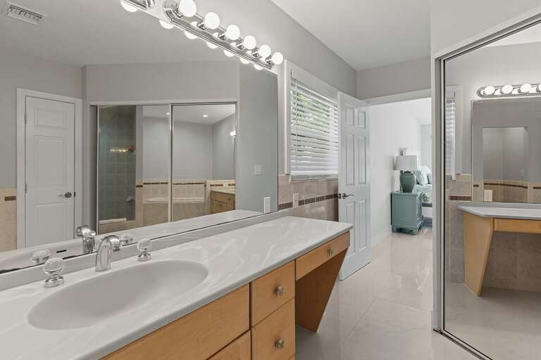 Master bathroom on the first level with large mirrors.