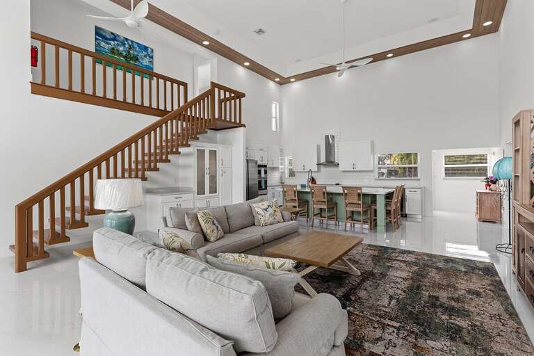Open concept kitchen, dining, and living room flooded with natural light.