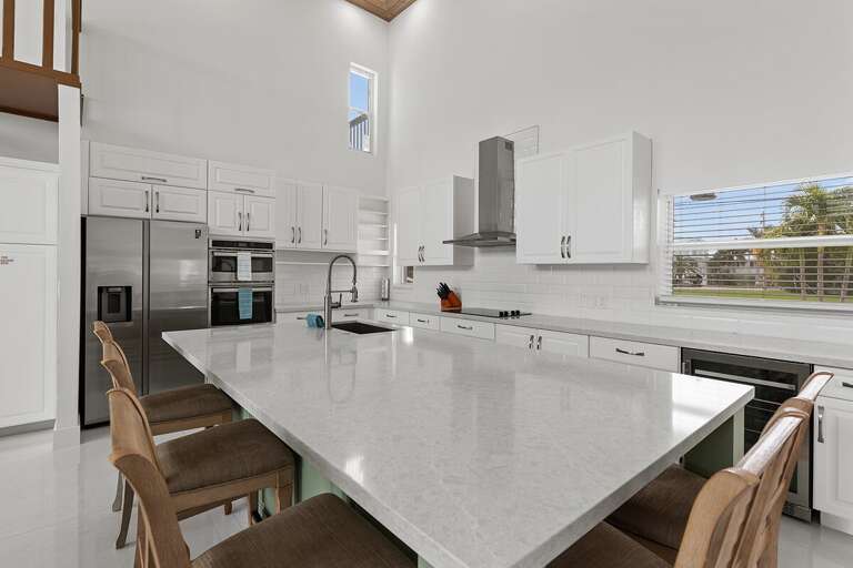Spacious kitchen island featuring a large center countertop with bar stools.