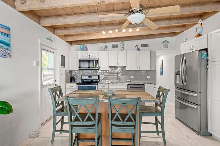 Bright and inviting dining area with seating for 4, conveniently located next to the kitchen for easy meal preparation and gatherings.