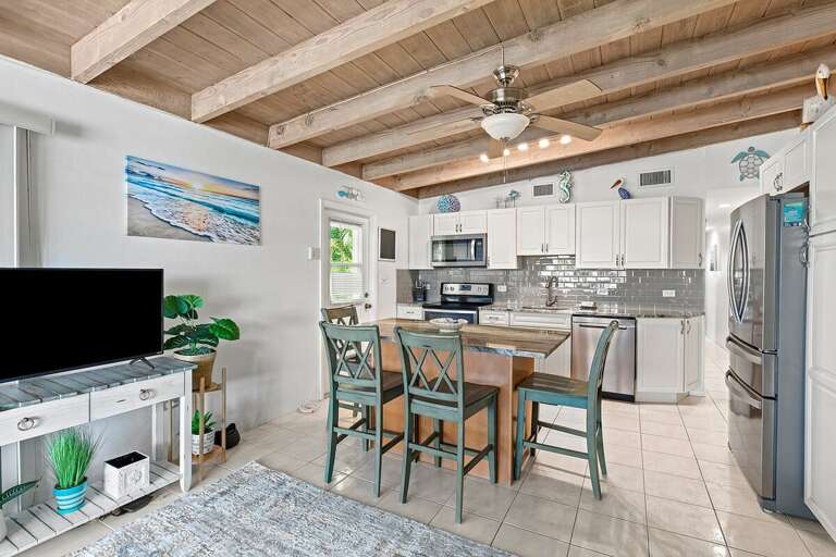 Bright and inviting dining area with seating for 4, conveniently located next to the kitchen for easy meal preparation and gatherings.