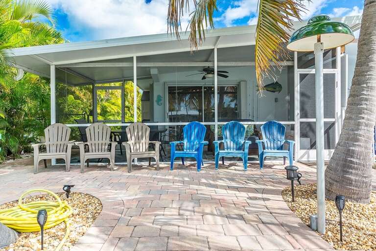 Enjoy the backyard oasis with cozy outdoor seating and ready-to-use kayaks for canal adventures and relaxation.