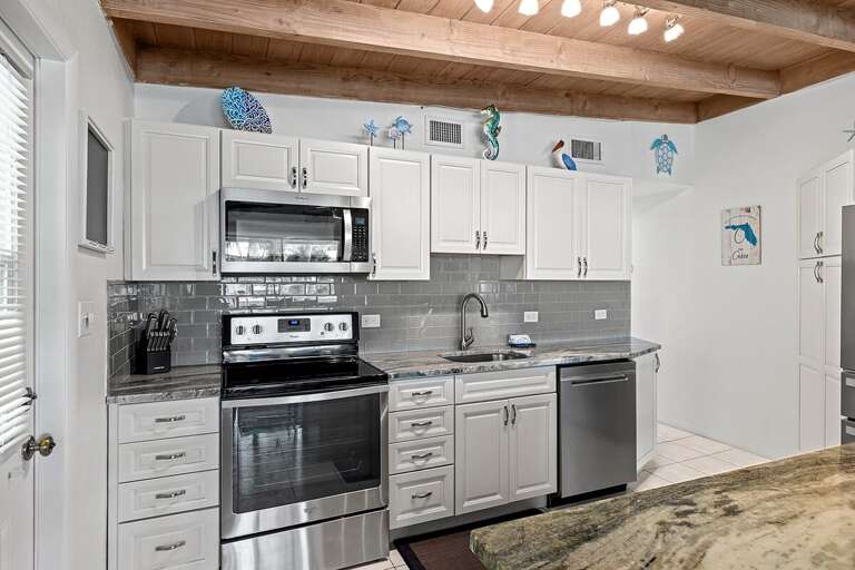 Fully equipped kitchen ready for your culinary creations, featuring modern appliances and ample counter space for cooking and entertaining.