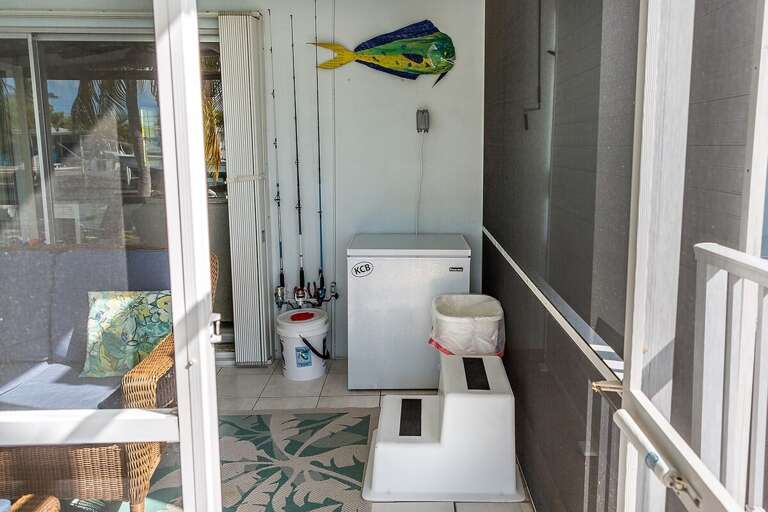 Relax and unwind in the screened-in lanai, offering a serene outdoor retreat with comfortable seating and protection from the elements.