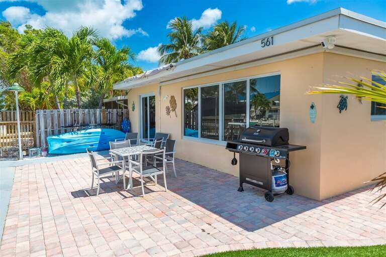 The backyard with a grill.