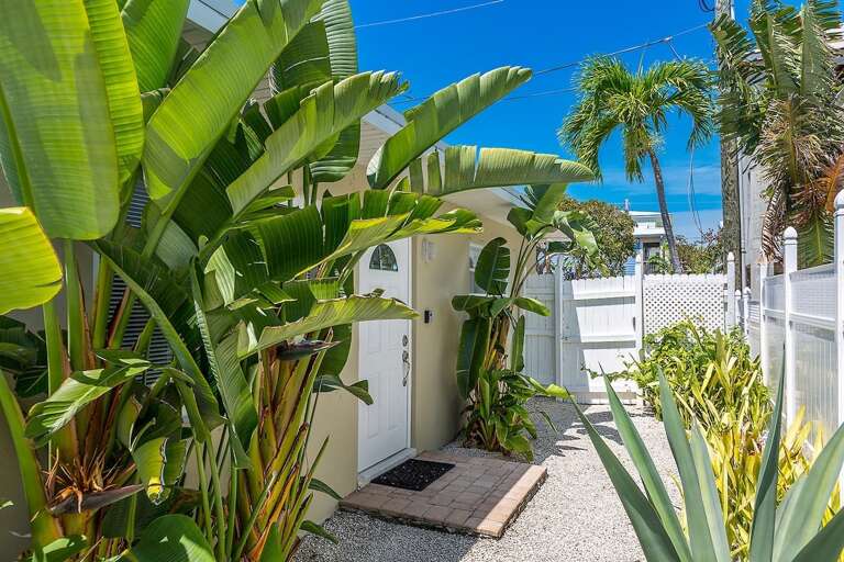 Lush, tropical landscaping decors this tropical oasis.