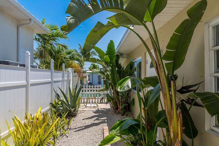 Private entrance surrounded by tropical landscaping.