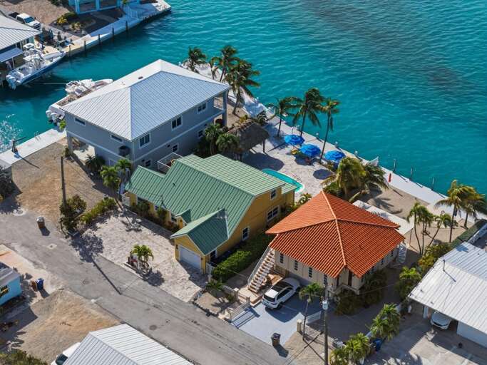 Aerial perspective of the oceanfront pool and outdoor living space at this luxury Marathon home.