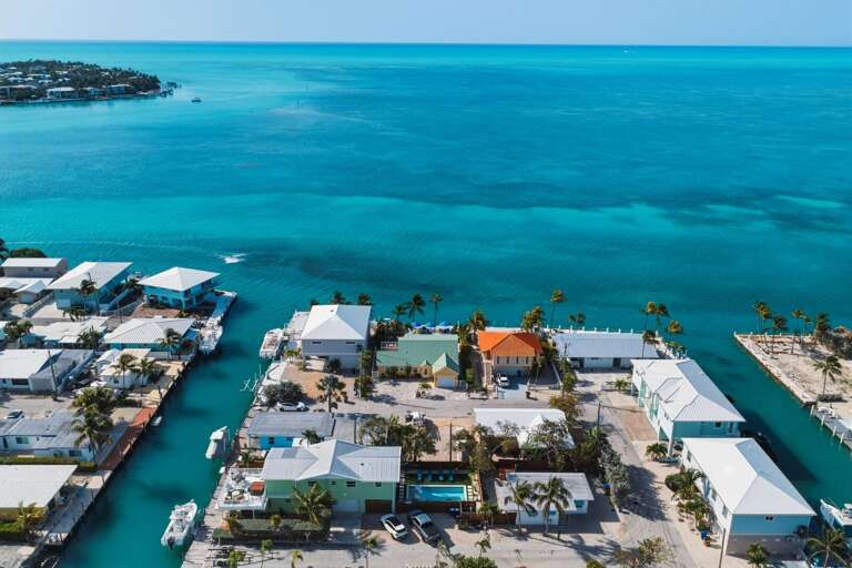 Aerial view showcasing unobstructed open water views surrounding this luxury oceanfront home in Marathon.