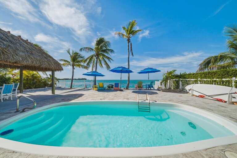 Heated (on request) oceanfront pool with tiki hut and unobstructed open water views at Mystic Waters in Marathon, FL.