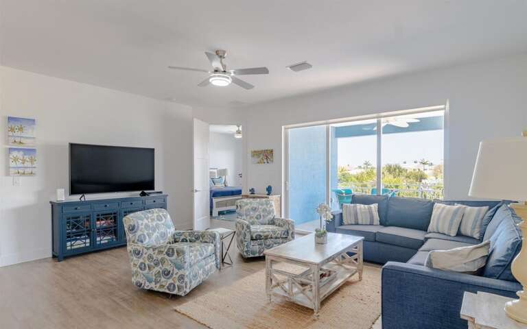 Charming living room decor with comfy seating arrangement and smart TV.