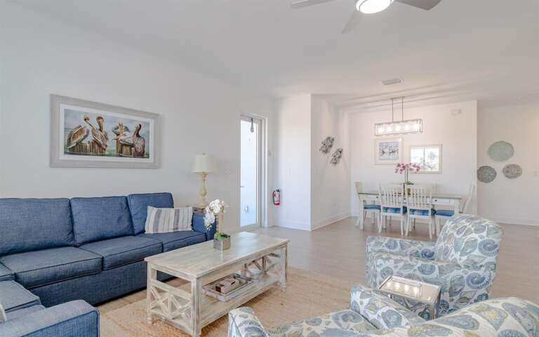 Charming living room decor with comfy seating arrangement and smart TV.