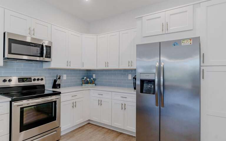 Fully stocked kitchen with Keurig coffee maker.