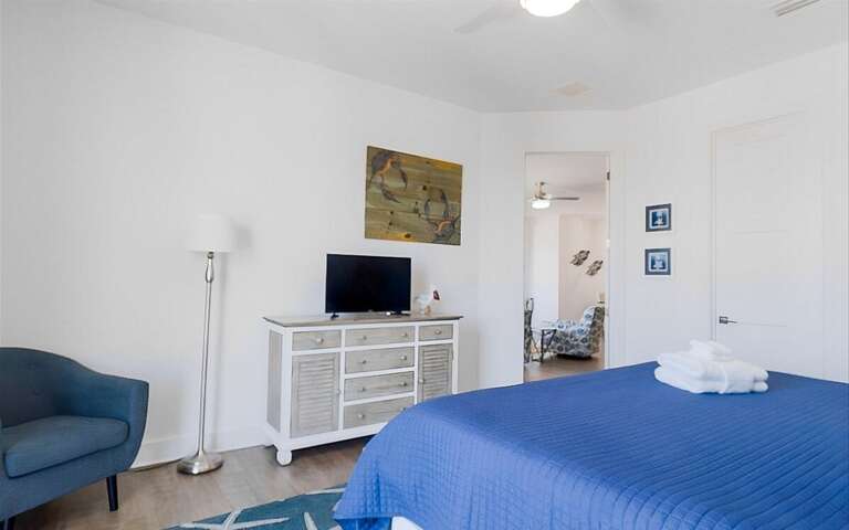 Master bedroom with king bed, ensuite bathroom, large walk-in closet, and private entrance to balcony. This is on the 2nd level.