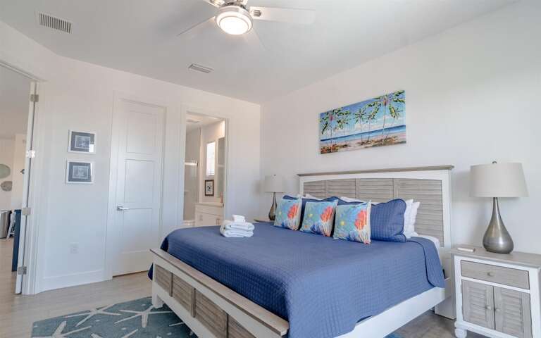 Master bedroom with king bed, ensuite bathroom, large walk-in closet, and private entrance to balcony. This is on the 2nd level.