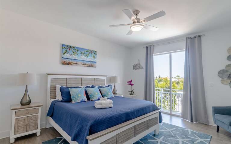 Master bedroom with king bed, ensuite bathroom, large walk-in closet, and private entrance to balcony. This is on the 2nd level.