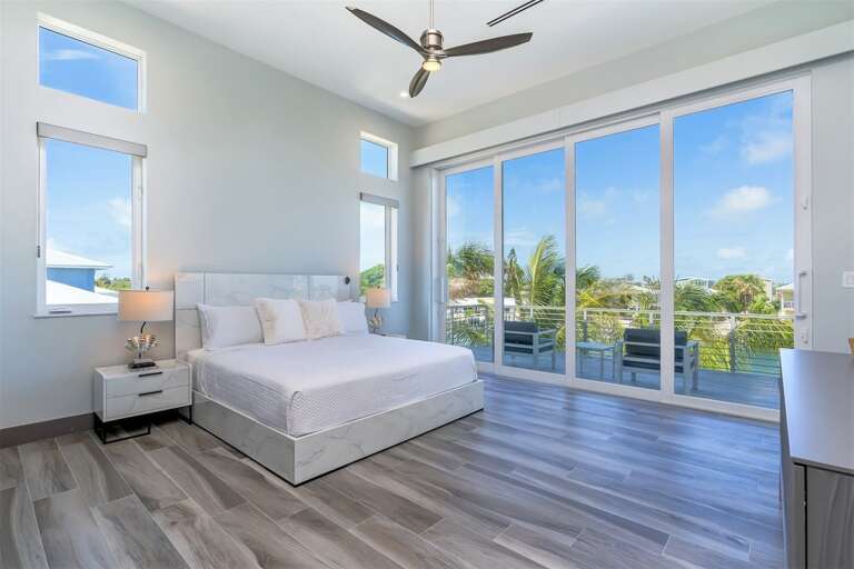 2nd level master bedroom with King size bed and water views from the private balcony. 2nd level master bedroom with King size bed and water views from the private balcony.