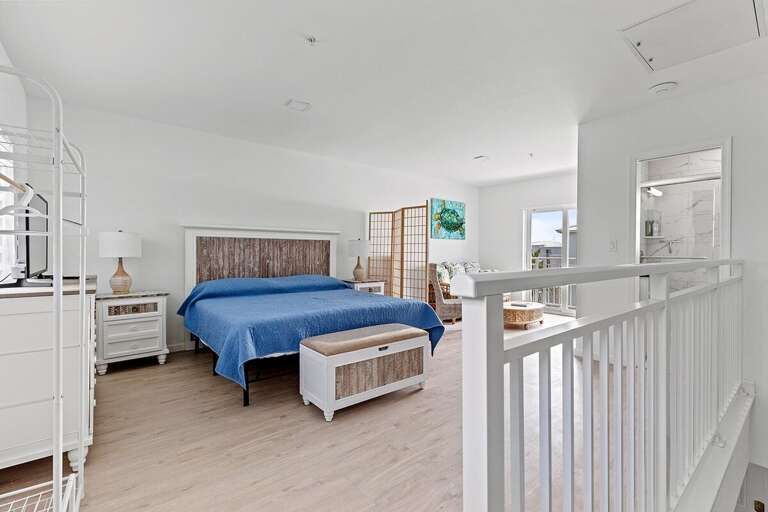 The 3rd level master suite with king size bed and seating area upstairs with full Bath.