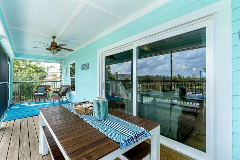 upstairs screened in porch with outdoor dining table