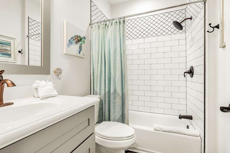 Indulge in the best of both worlds with our full bathroom featuring a shower and tub combo.